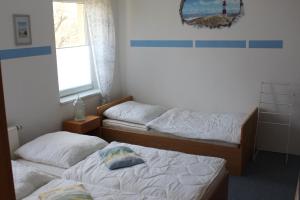 Ferienwohnung Beim Rößl tesisinde bir odada yatak veya yataklar