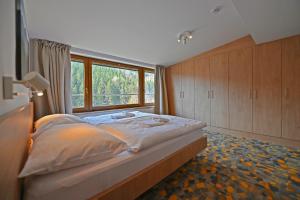 a bedroom with a large bed and a window at Vetrnik Depandance Hotelu Jirinka in Dolní Morava +30 photos