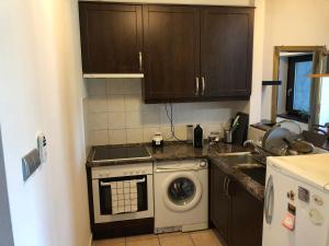 a kitchen with a sink and a washing machine at Brown house in Budapest