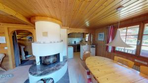 a kitchen and living room of a tiny house with a fireplace at Saxo in Blatten bei Naters