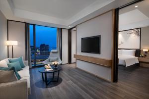 TV a/nebo společenská místnost v ubytování Fuzhou Mawei Yiho Hotel