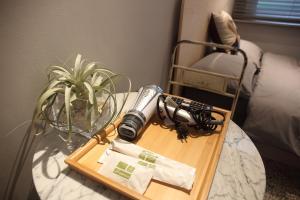 a wooden table with a camera on top of a table at Spring Guest House in Tainan