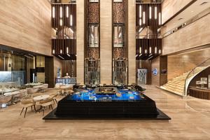 a lobby with a large fountain in the middle of a building at Fortune Park, Vellore - Member ITC's Hotel Group in Vellore