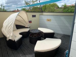 a patio with a tent and stools on a deck at ATELIER 85 in Les Épesses
