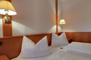 a hotel room with two white pillows on a bed at Michel Hotel Wetzlar in Wetzlar +21 photos