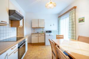 a kitchen with a table and a dining room at Landhaus Fingerhof in Flachau