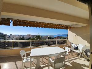 a balcony with a table and chairs and a view at Vezelay, by Welcome to Cannes in Cannes