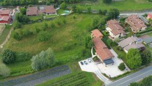 an overhead view of a house with a field and a road at Agriturismo Terra e Lago d'Iseo Franciacorta in Paratico