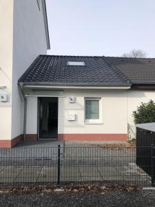 a white house with a black roof at Apartment Martinstraße 7b in Hannover