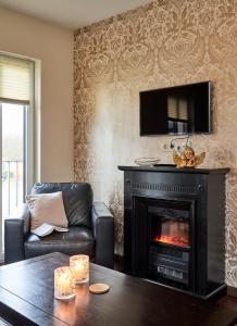 a living room with a fireplace with a tv above it at Scharhörn-Riff - 16 in Cuxhaven