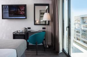 a bedroom with a bed and a television at Astor Hotel in Athens