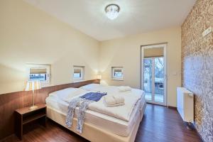 a bedroom with a large bed and a television at Scharhörn-Riff - 16 in Cuxhaven