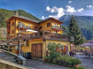 a large yellow building with balconies on it at Le Nid de l'Aigle in Champoluc