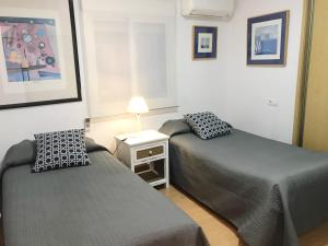 Posteľ alebo postele v izbe v ubytovaní Apartamento Millán