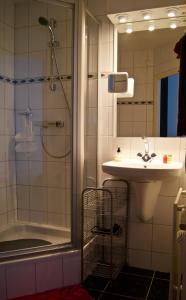 a bathroom with a shower and a sink at The Studio Guesthouse in Volendam