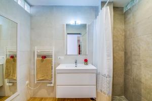 a bathroom with a white sink and a mirror at Ideal Property Mallorca - Blue Attic Beach in Alcudia
