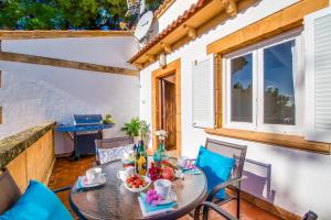 eine Terrasse mit einem Tisch, Stühlen und einem Fenster in der Unterkunft Ideal Property Mallorca - Sol de Mallorca 2 in Cala Mesquida