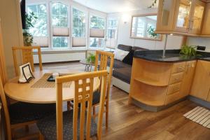 a kitchen and living room with a table and a couch at Domek na Skarpie in Zakopane