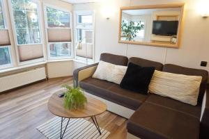 a living room with a couch and a table at Domek na Skarpie in Zakopane