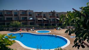 a large swimming pool in front of a building at Okeanos sea view 1 bedroom VR-S in Granadilla de Abona