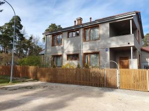 a house with a wooden fence in front of it at 19 Jasminu street in Jūrmala