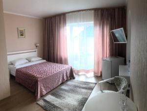 a hotel room with a bed and a window at For You in Odesa +45 photos
