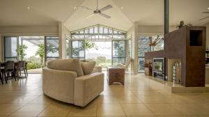 a living room with a couch and a fireplace at Belle Bois, Capertee Valley in Glen Alice