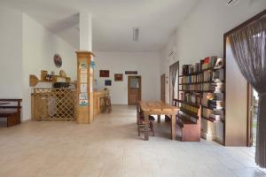 una habitación con una mesa y un estante de libros en Agriturismo Podere San Giorgio, en Otranto