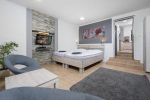 a living room with a large bed and a television at Apartmá SunGarden Liberec in Liberec
