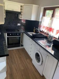 a kitchen with a washer and dryer on a counter at Flat 18 in Dumfries