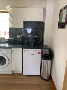 a kitchen with a microwave and a refrigerator at Flat 18 in Dumfries