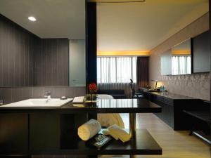 a bathroom with a sink and a counter top at FX Hotel Taipei Nanjing East Road Branch in Taipei