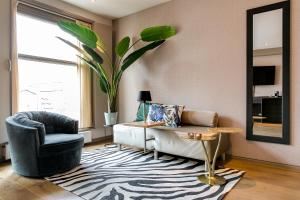 un soggiorno con divano e sedia di Brasss Hotel Suites a Haarlem