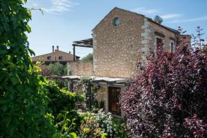 a brick building with a bunch of plants at Villa Eleonas in Vamos