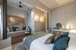 a bedroom with a large bed and a couch at Castellano Hotel & Suites in Nafplio