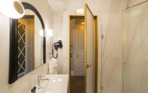 a bathroom with a sink and a mirror at Castellano Hotel & Suites in Nafplio +83 photos