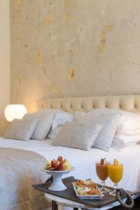 a bed with a tray of food on a table at Castellano Hotel & Suites in Nafplio