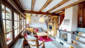 a room with a living room with a fireplace at Tschuggen 61 in Blatten bei Naters