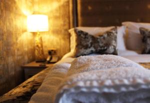 a bedroom with a bed with a lamp on a table at The Lord Street Hotel; BW Signature Collection in Southport