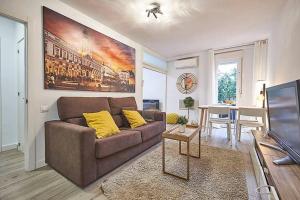 a living room with a brown couch and a table at Apartment SAN MIGUEL in Madrid