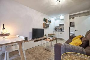 a living room with a couch and a table with a tv at Apartment SAN MIGUEL in Madrid