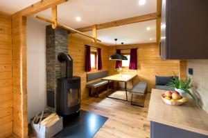 a kitchen and living room with a wood stove at MarktlAlm Turracher Höhe in Turracher Hohe