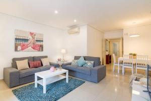 salon z kanapą i stołem w obiekcie TGH Málaga we love the sea w Maladze