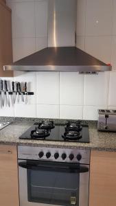 a kitchen with a stove top oven in a kitchen at Apartamento Mediterraneo in Pineda de Mar
