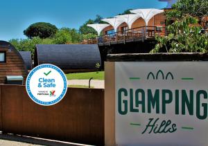 a sign in front of a fence in front of a house at Glamping Hills in Santa Comba de Rossas