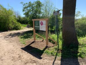 a sign in the dirt next to a tree at Pullevaart in Elim