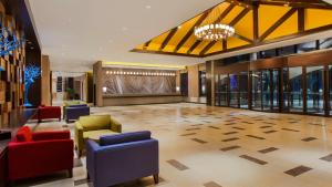 a lobby with colorful chairs and a chandelier at Holiday Inn Express Changbaishan, an IHG Hotel in Fusong