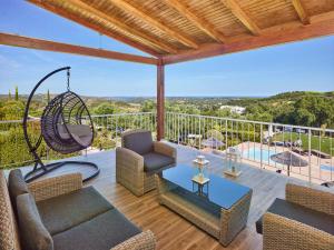 a living room filled with furniture and a balcony at Hotel Rural Quinta do Marco - Nature & Dining in Tavira