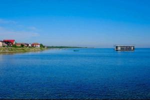 a large body of water with a house in the middle at Villa Baltic - Apartament Chałupy nr 6 in Chałupy