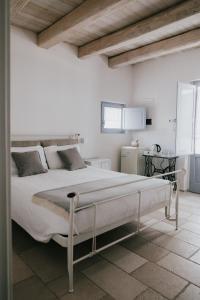 מיטה או מיטות בחדר ב-L'Ulivo Bianco
